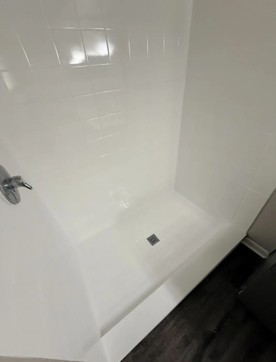 Glossy reglazed shower pan and tile walls by Narbra Maintenance in Central Florida